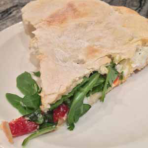 sicilian stuffed pizza with ricotta and arugula